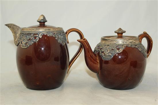 Wedgwood treacle glazed pottery silver mounted part tea set, c.1906, the hot water pot 13cm., one plate broken (13)(-)